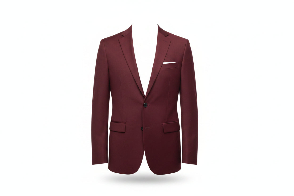 Man in a burgundy blazer and sunglasses standing on a balcony with a cityscape background