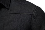 Close-up of a dark charcoal gray textured fabric, showing a collar and shoulder seam detail.